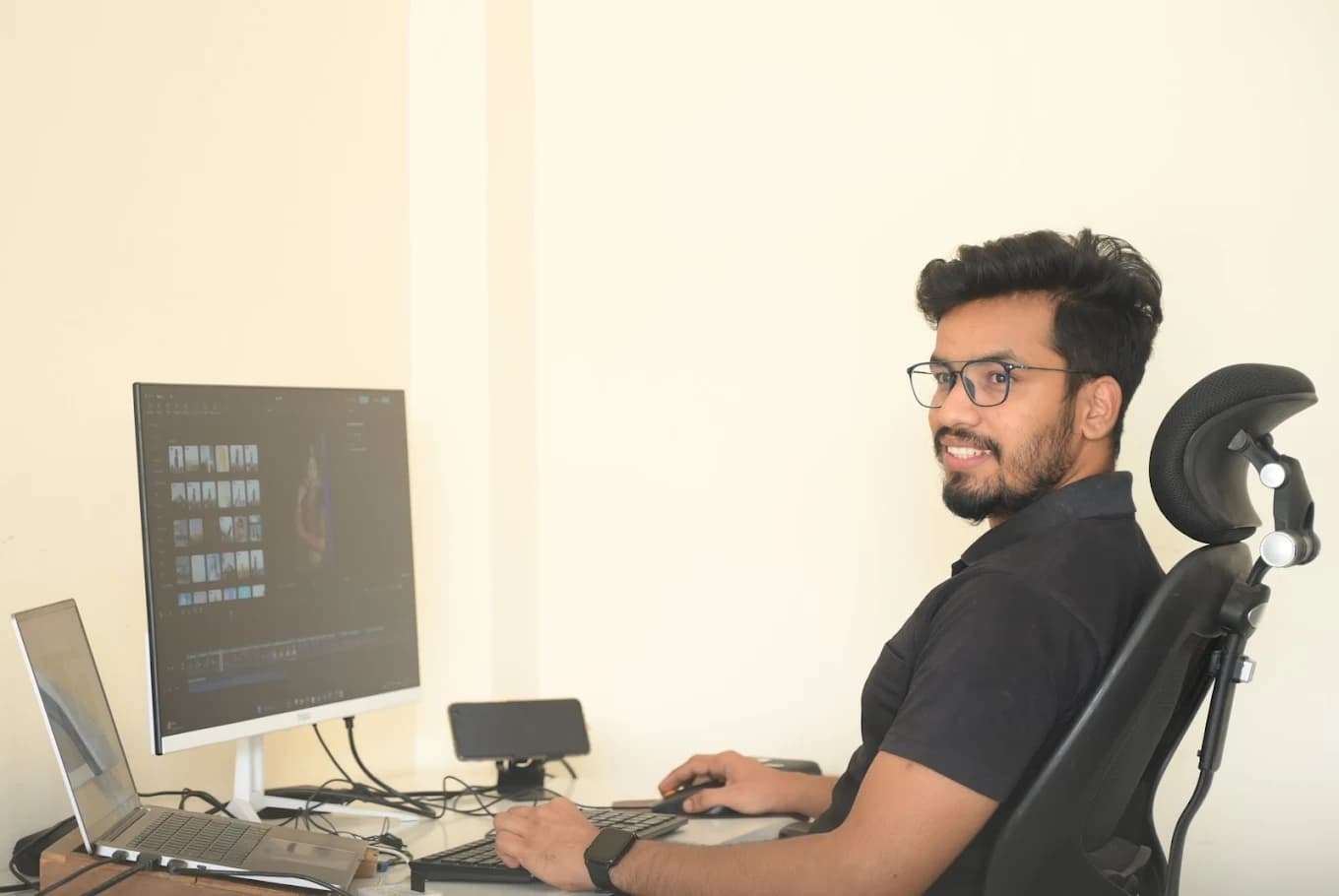 A video editor working at a post-production desk
